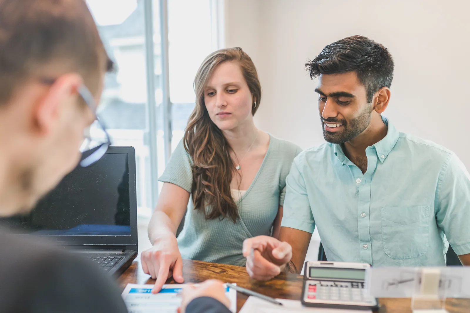 A professional advisor discussing financial documents with clients
