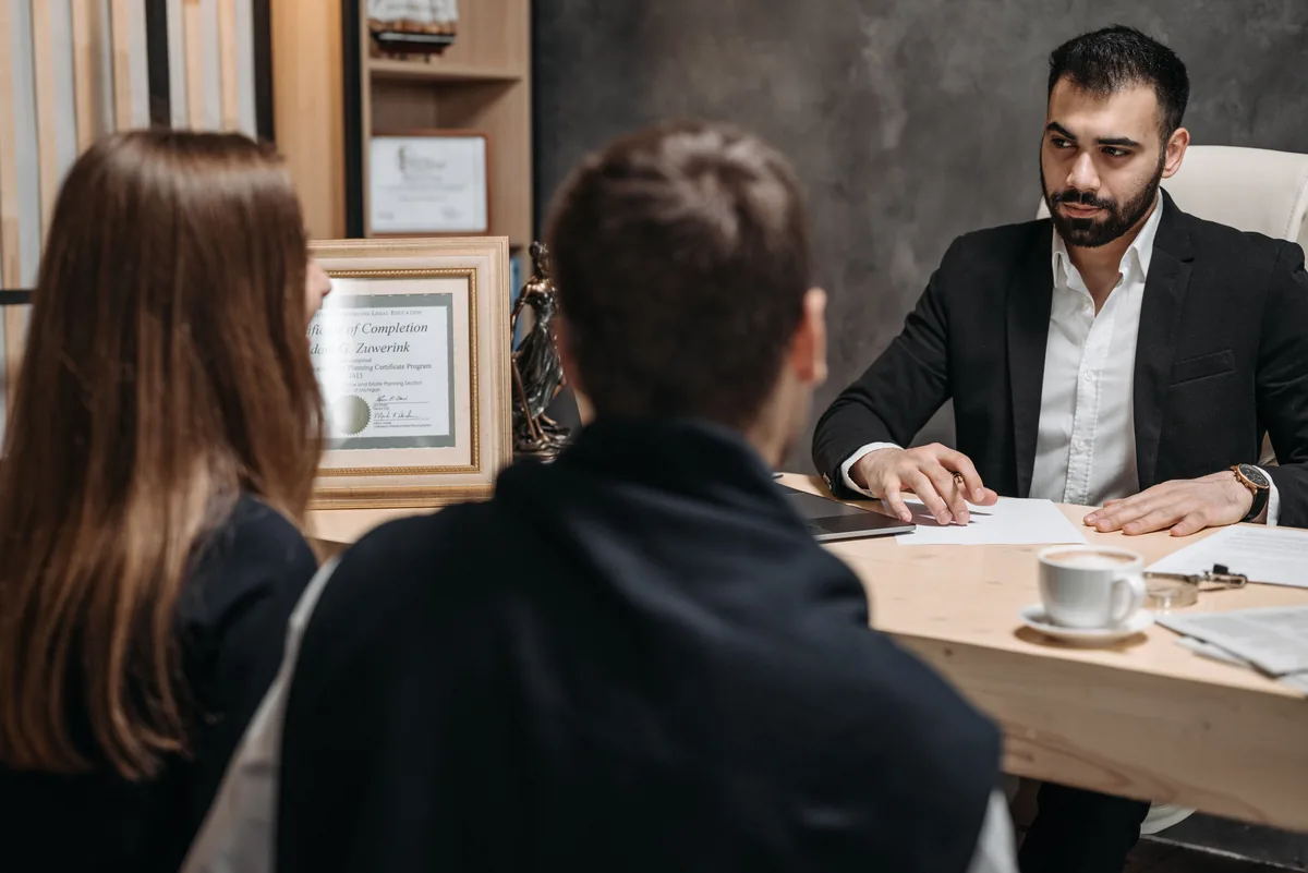 A professional advisor meeting clients to discuss documents