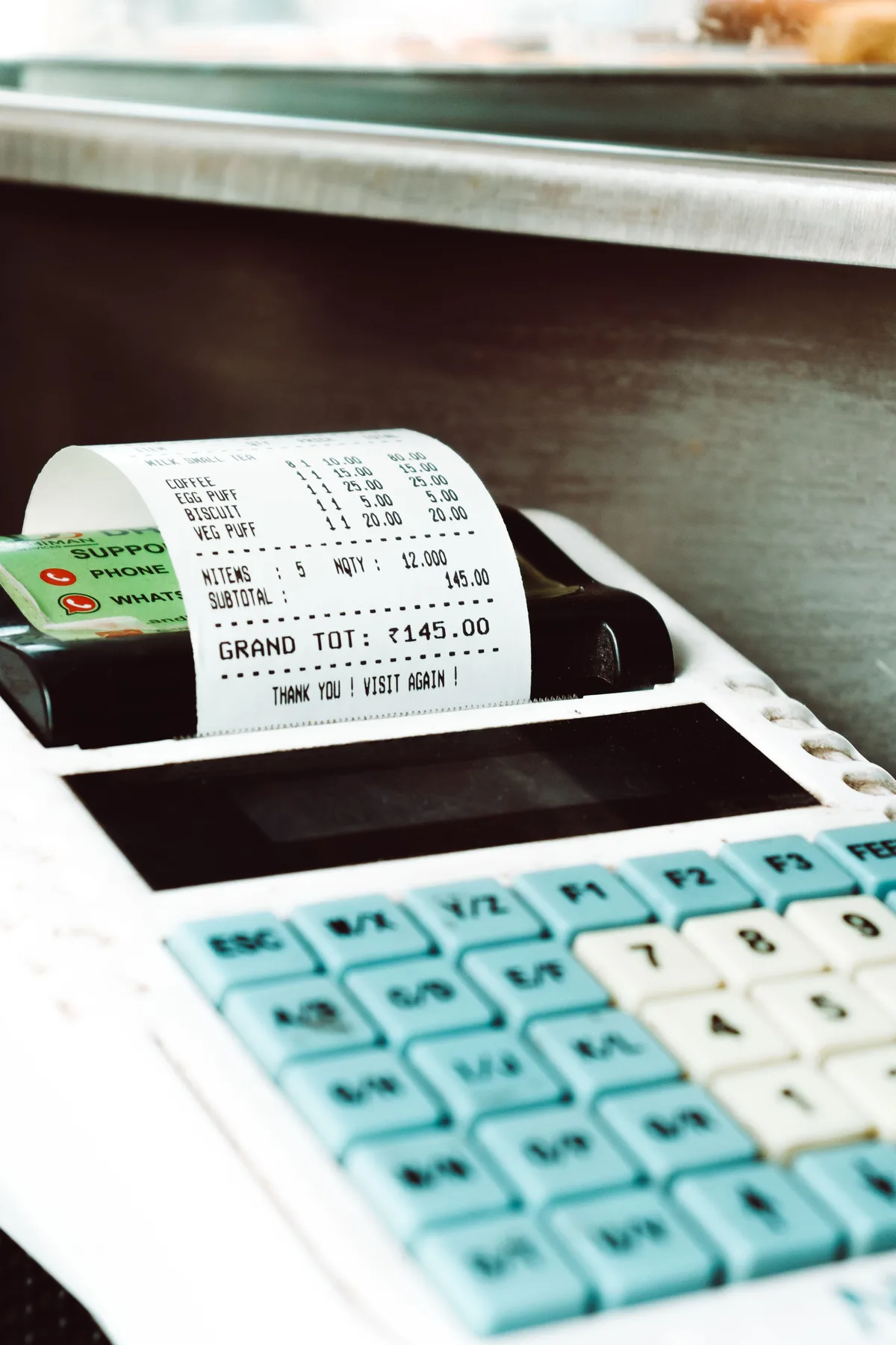 A sales receipt being printed at a cash register